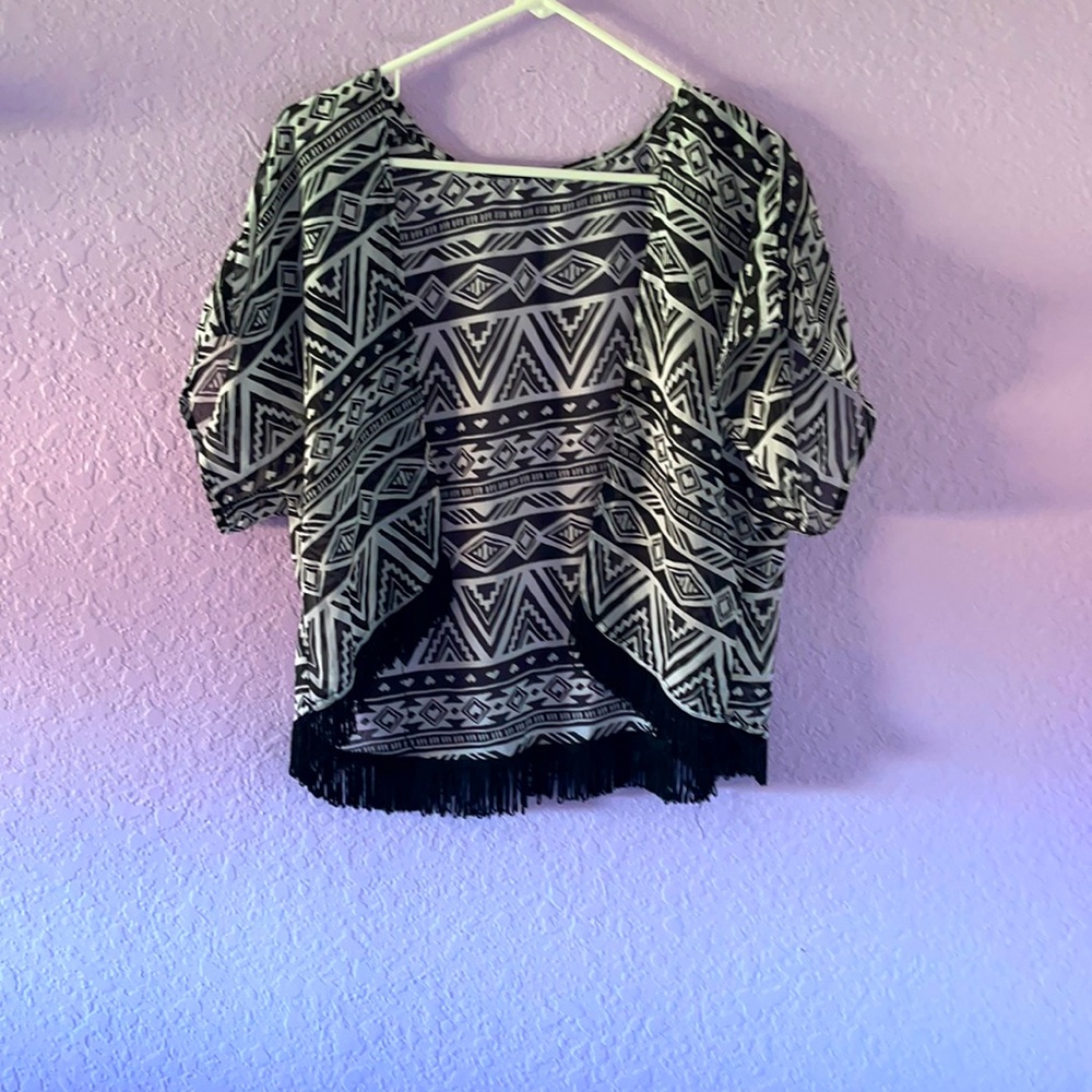 A stylish light jacket with dangling fabric at the ends